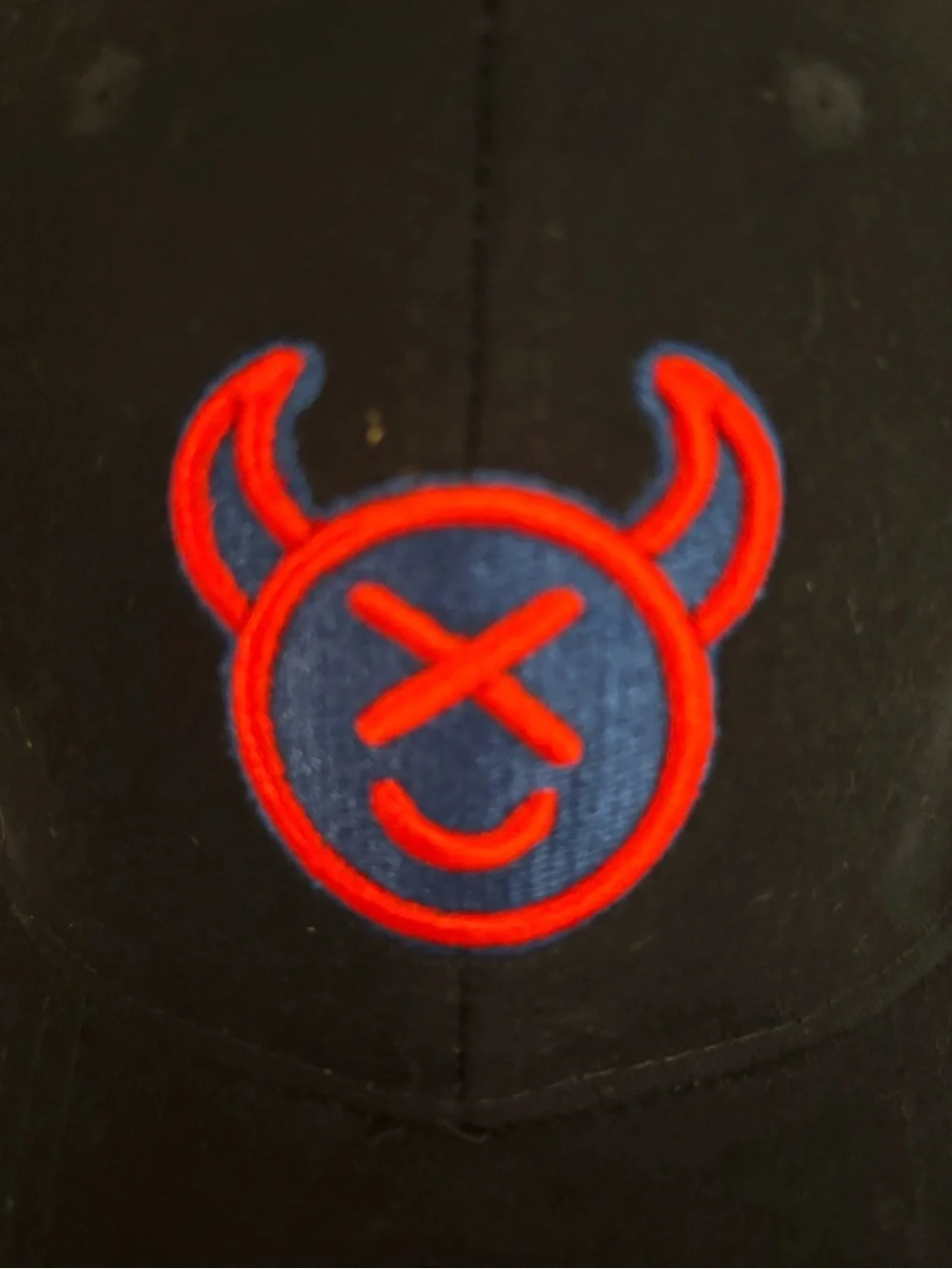 Source Unknown Black Cap with Red & Blue Devil Emblem
